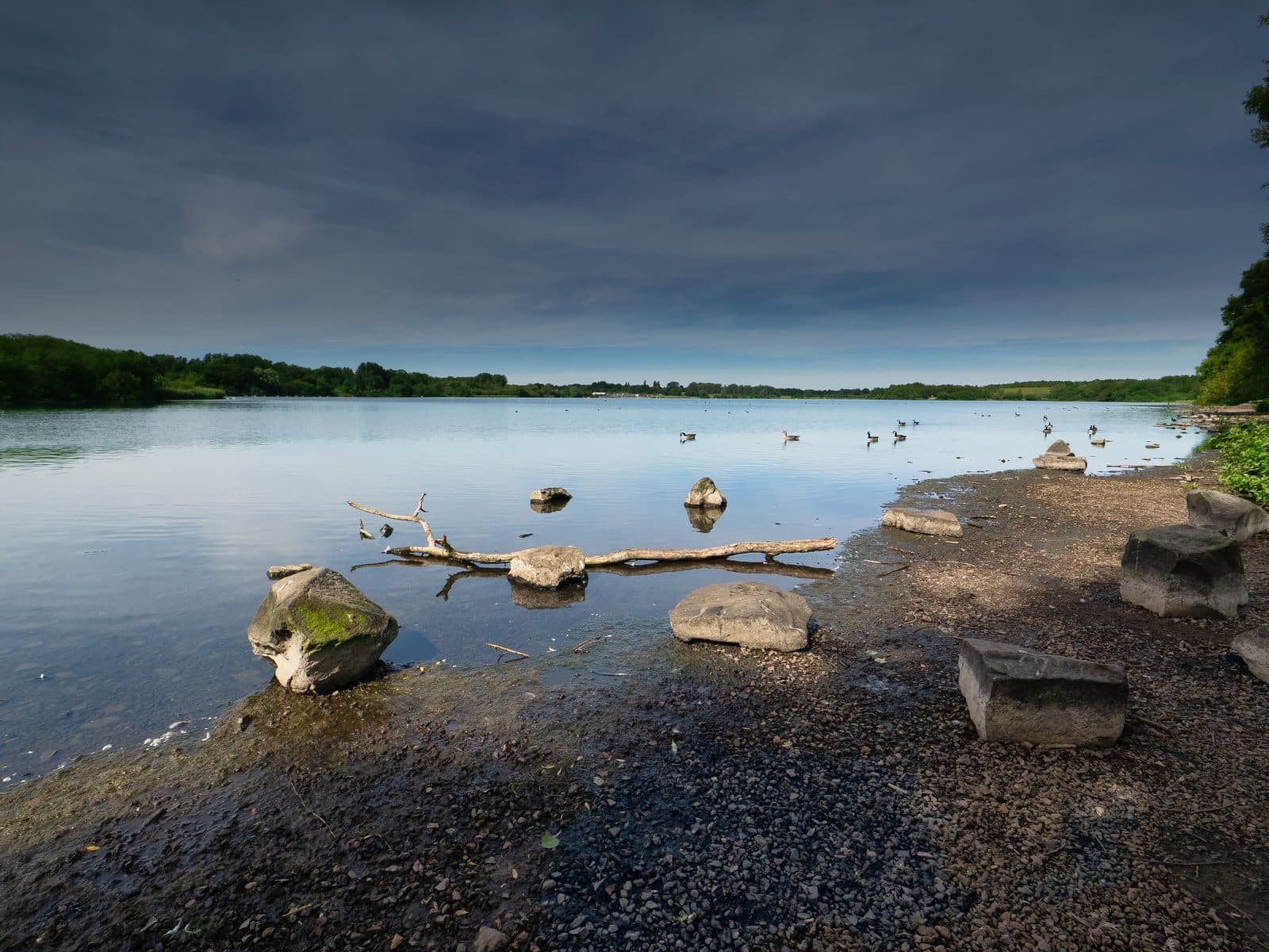 Rocky shoreline of the flash at Pennington Flash Country Park, Greater Manchester