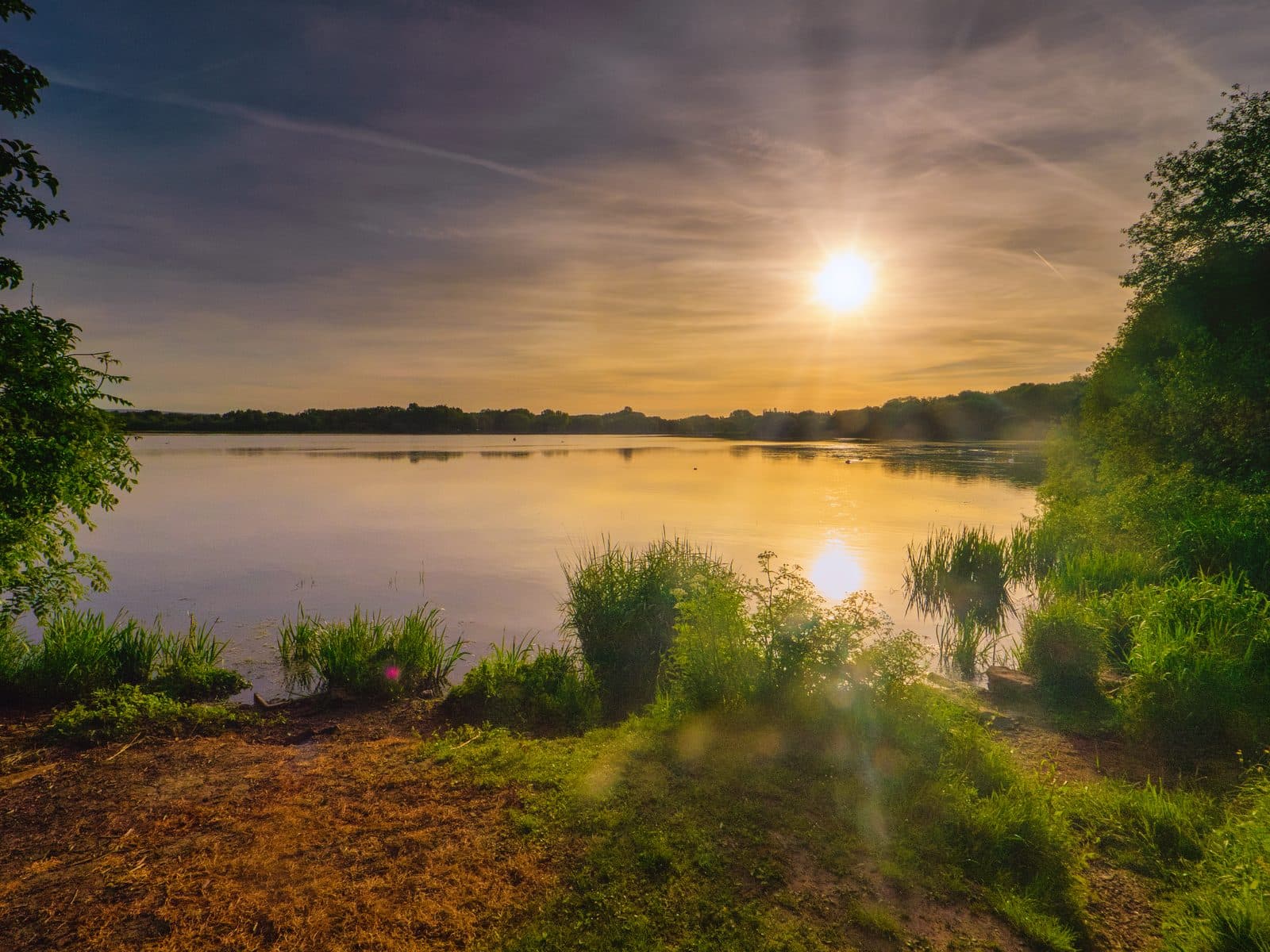 Golden sunset over the water at Pennington Flash Country Park, Greater Manchester